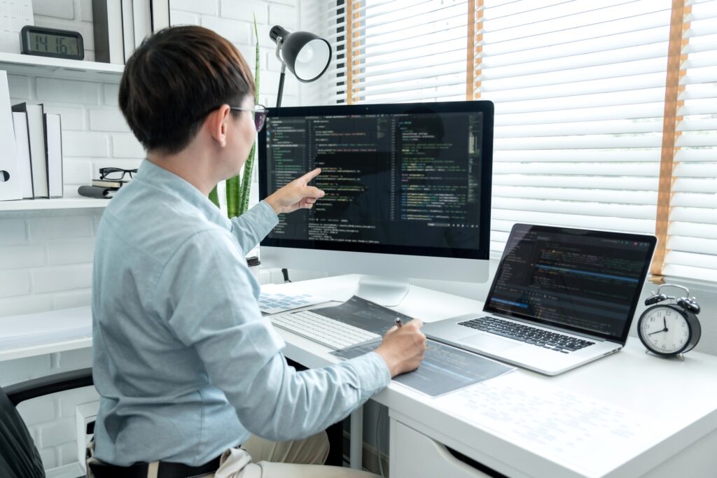 Male programmer is programing to developing program app and website of corporate while working